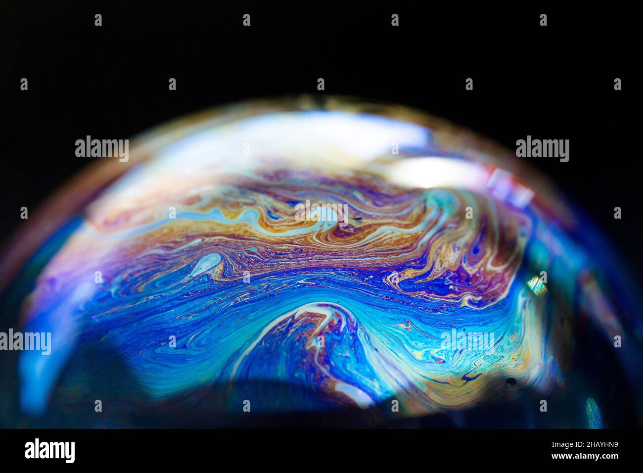 Abstract pattern, multicolored chaotic texture inside of the soap bubble, closeup Stock Photo