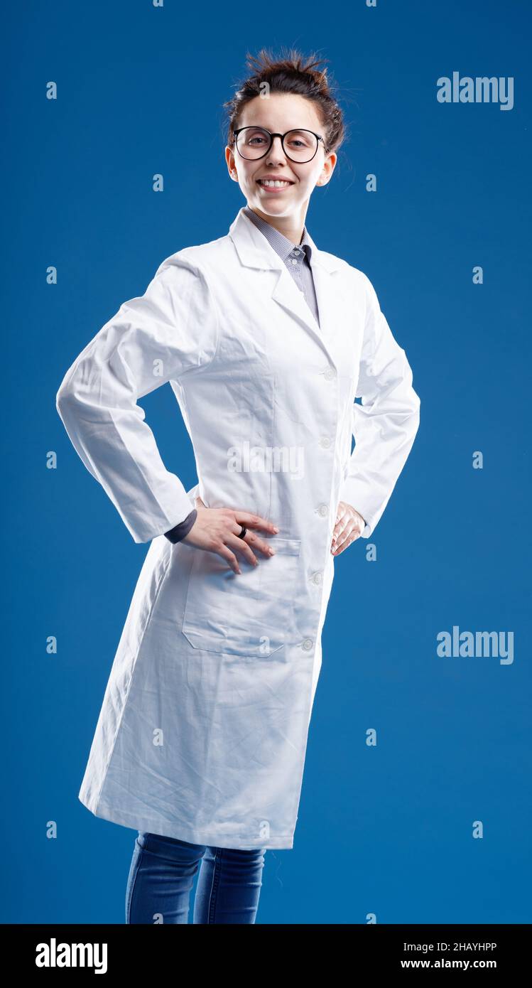 proud and happy family female medical doctor with arms akimbo, ready to solve problems, could be also a researcher because of her white coat Stock Photo