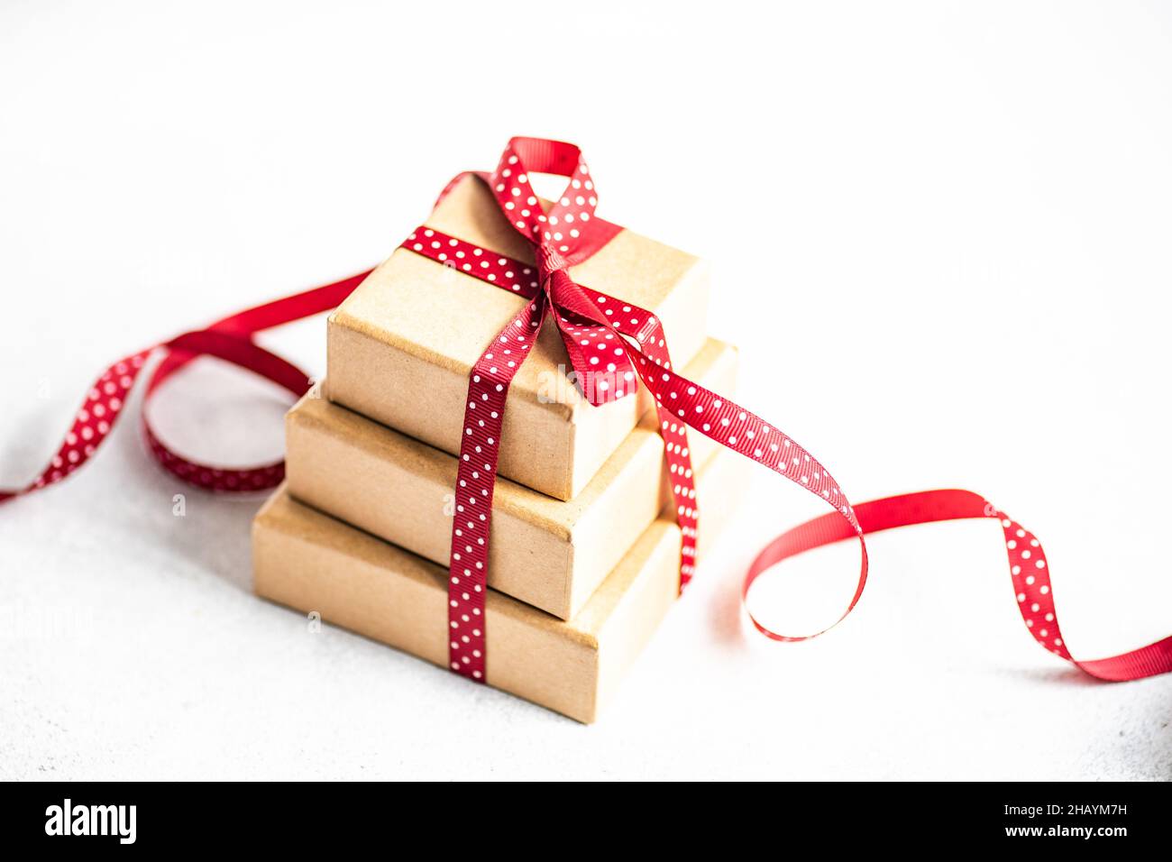 Stack of three gift boxes tied with a red ribbon Stock Photo