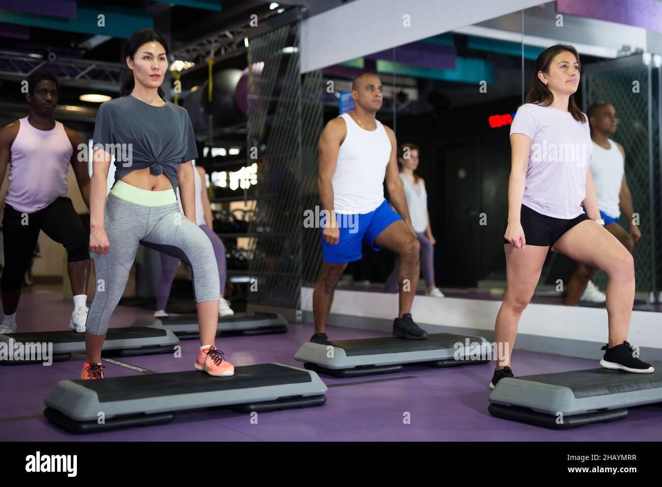 People training on step platforms in gym Stock Photo Alamy
