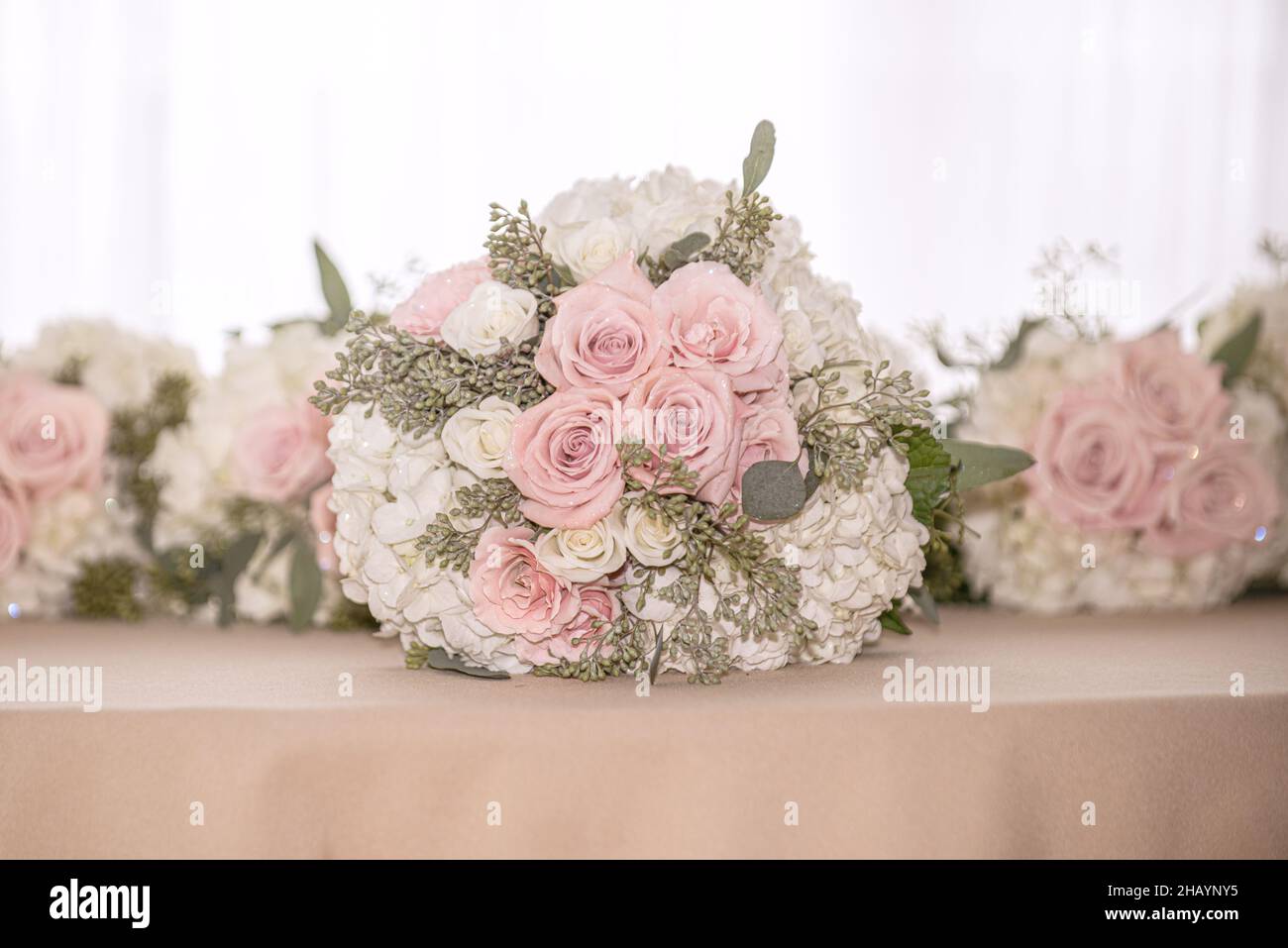 Pink and white roses with white hydrangea bridal party bouquets lined ...
