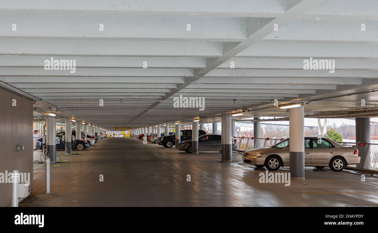 Parking interior. Parking garage in New Westminster BC. Multi-storey car park. Street photo, selective focus Stock Photo