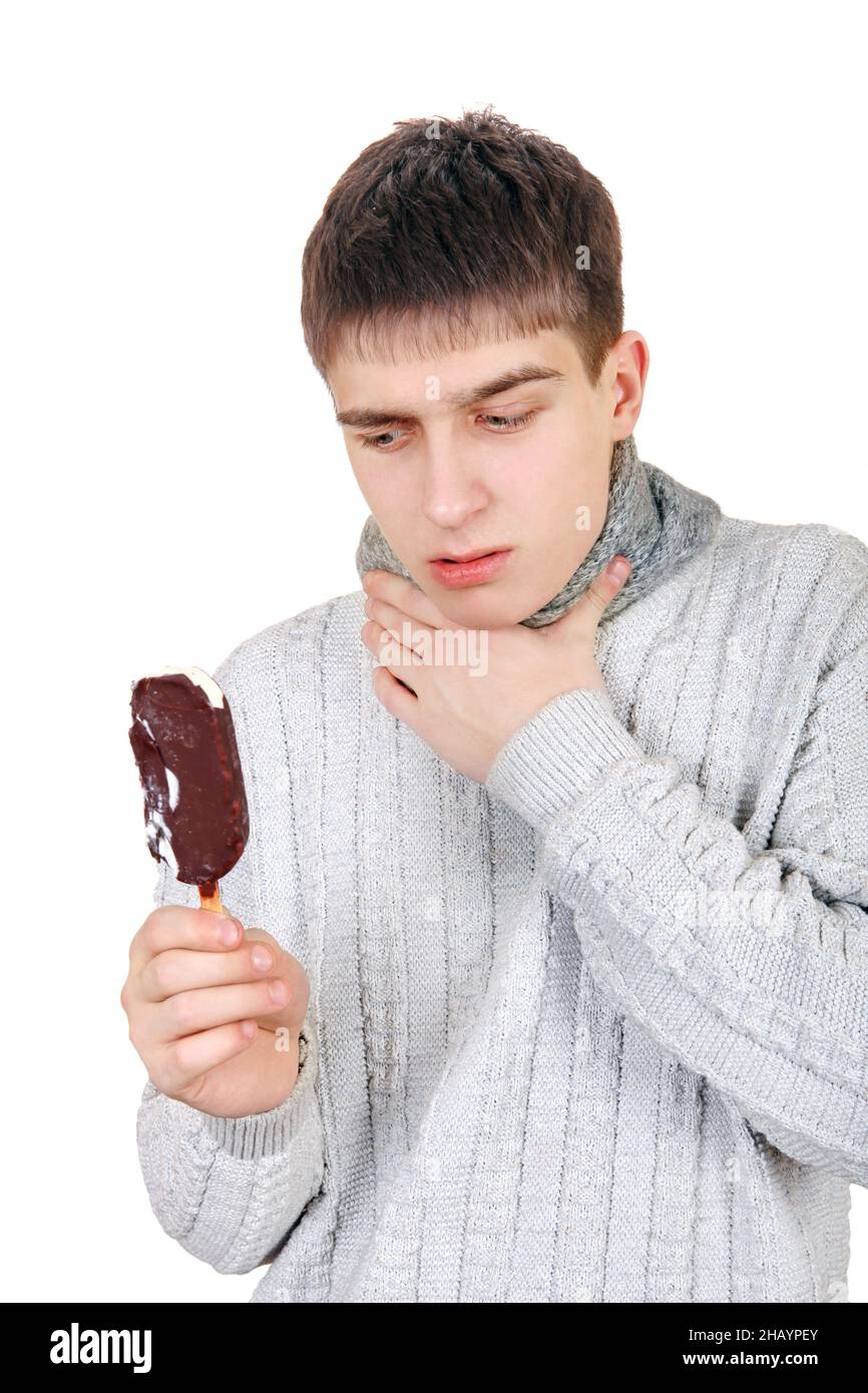 Sick Teenager eats Icecream Isolated on the White Background Stock Photo