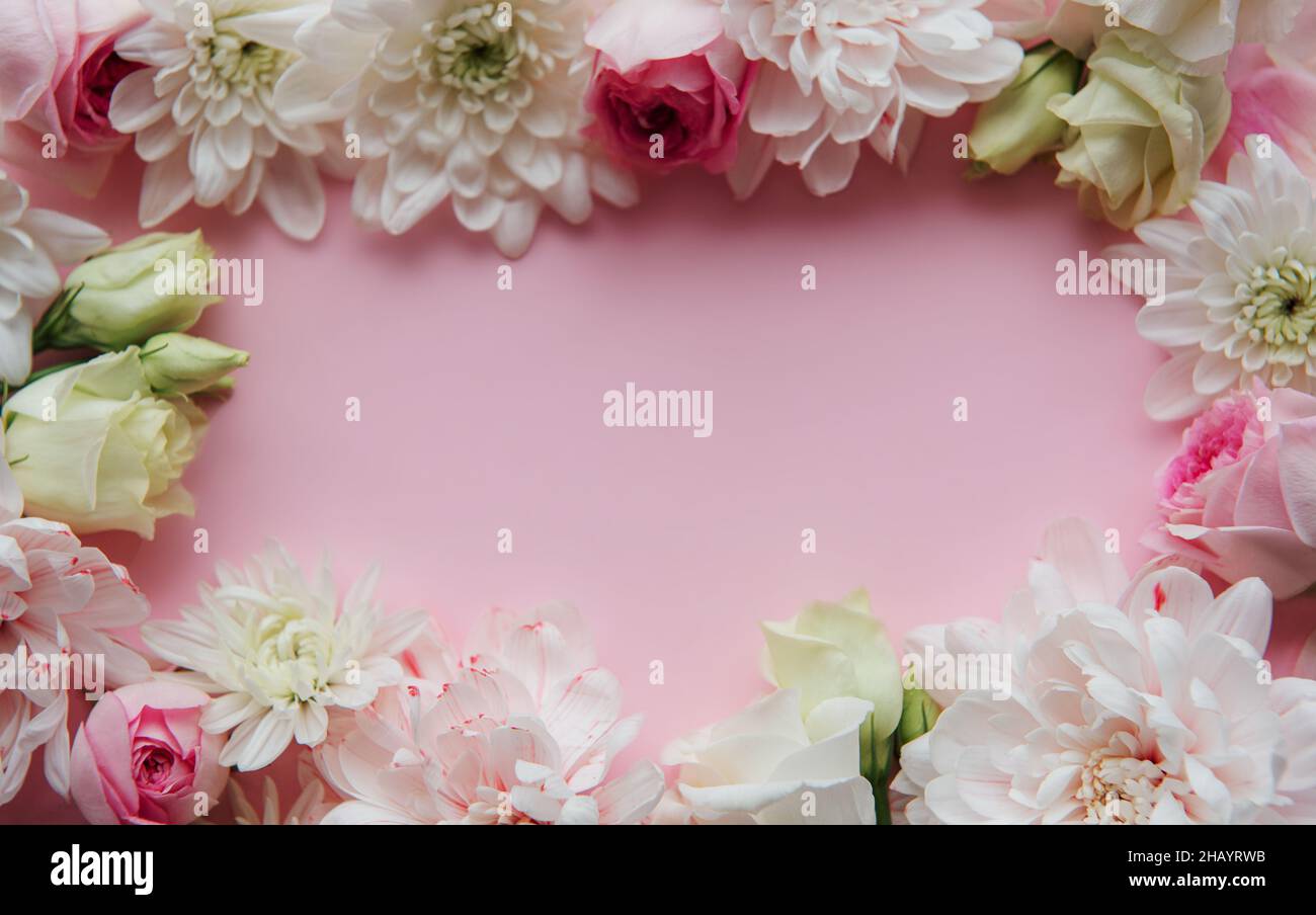 Frame made of flowers on pastel pink background Stock Photo - Alamy