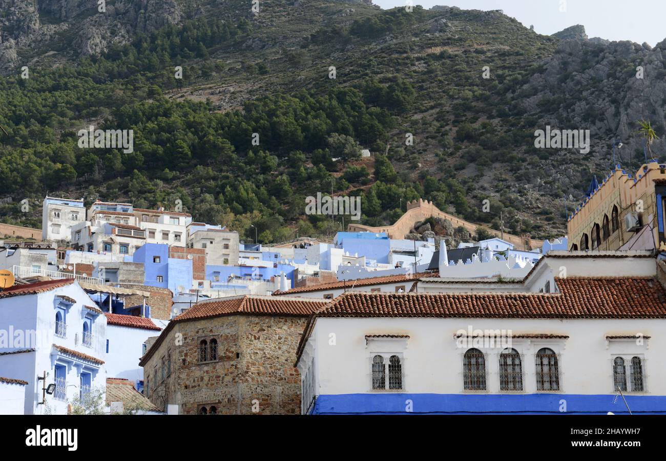 Looking up at the mountains rising above the medina of Chefchaouen, Morocco. Stock Photo