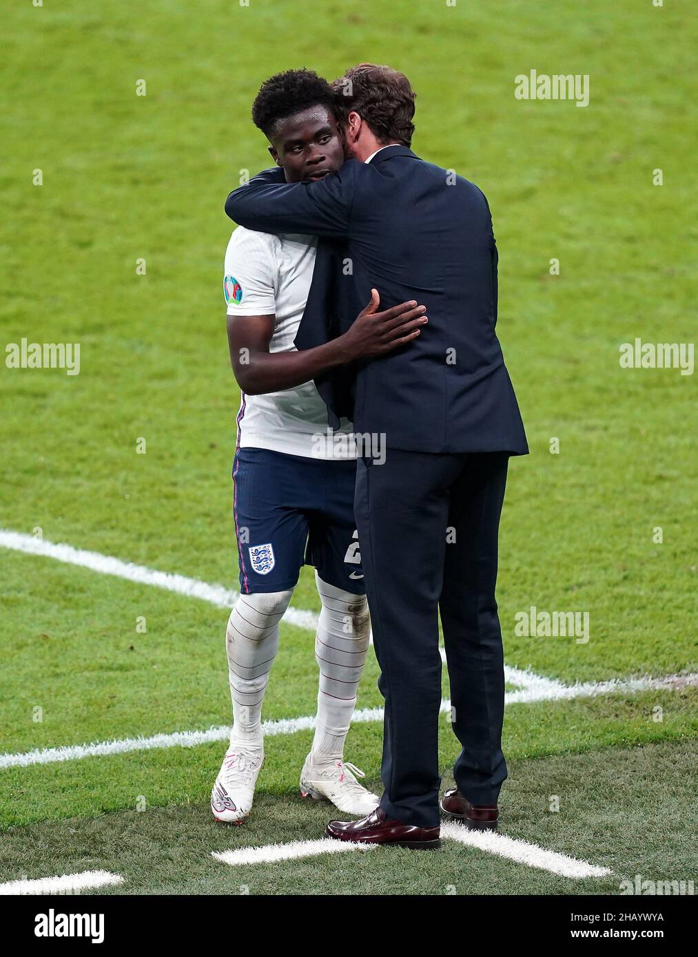 File photo dated 07-07-2021 of England manager Gareth Southgate with Bukayo Saka. England’s run to the Euro 2020 final and raised hopes of a first major men’s tournament success for England since 1966. The run ended in chaotic, ugly scenes at the final itself and with vile abuse spouted on social media in the aftermath, as a tiny minority turned on the men brave enough to step up for their country and take penalties when it mattered most. Issue date: Thursday December 16, 2020. Stock Photo