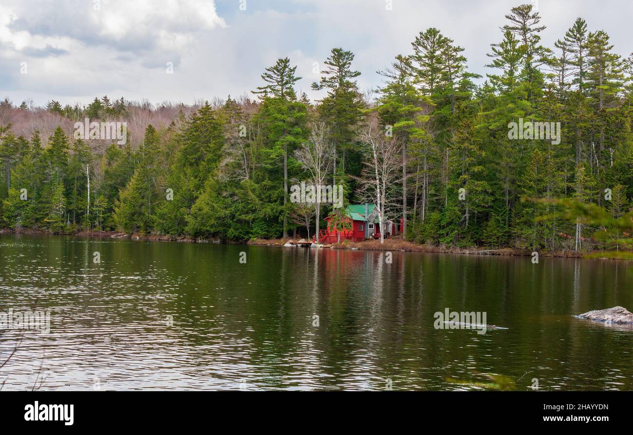 A red cabin by a mountain lake, in a sprucefirnorthern hardwood forest. Kettle Pond State Park