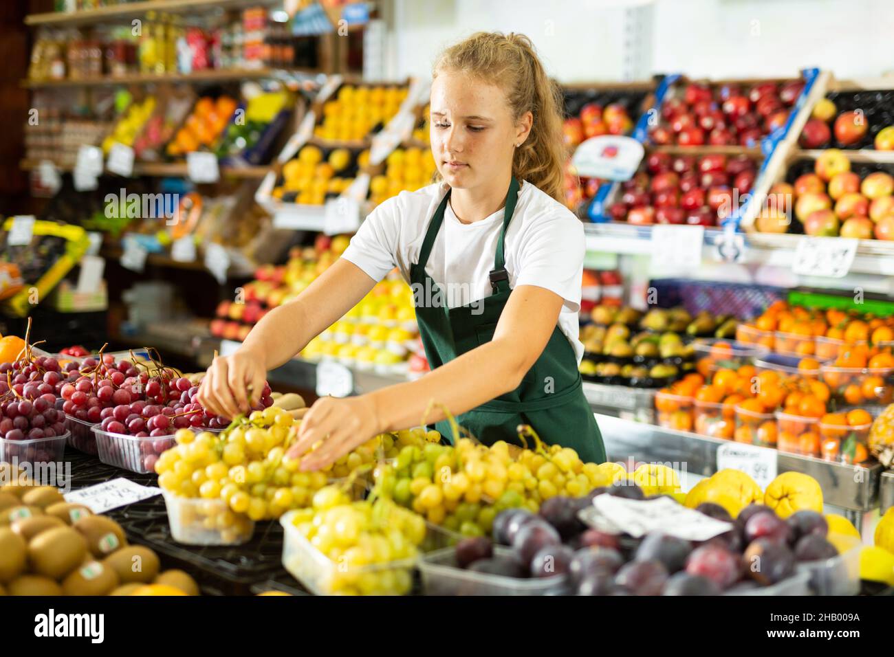 Teenage girl working in grocery as job experience Stock Photo Alamy