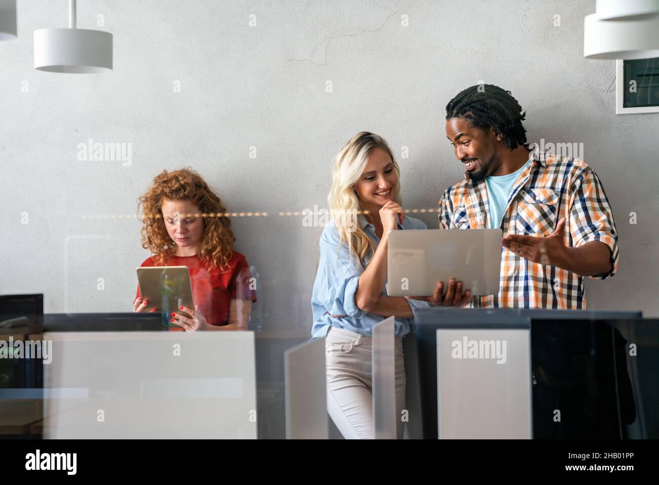 Happy smiling business colleagues working together online on a tablet in office Stock Photo