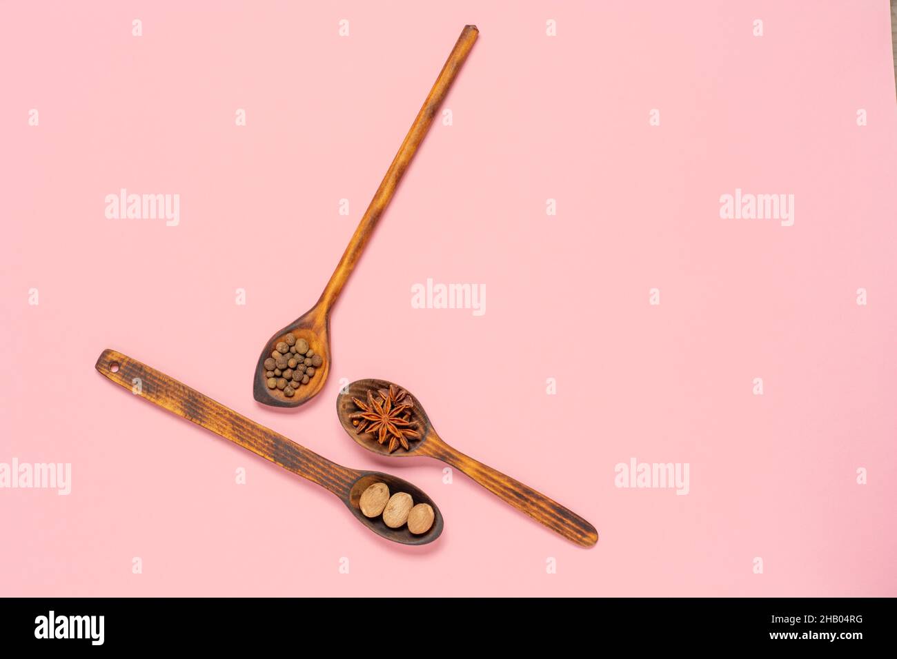 anise star, nutmeg and allspice in spoon on colorful background with copy space. Flat lay background. Stock Photo