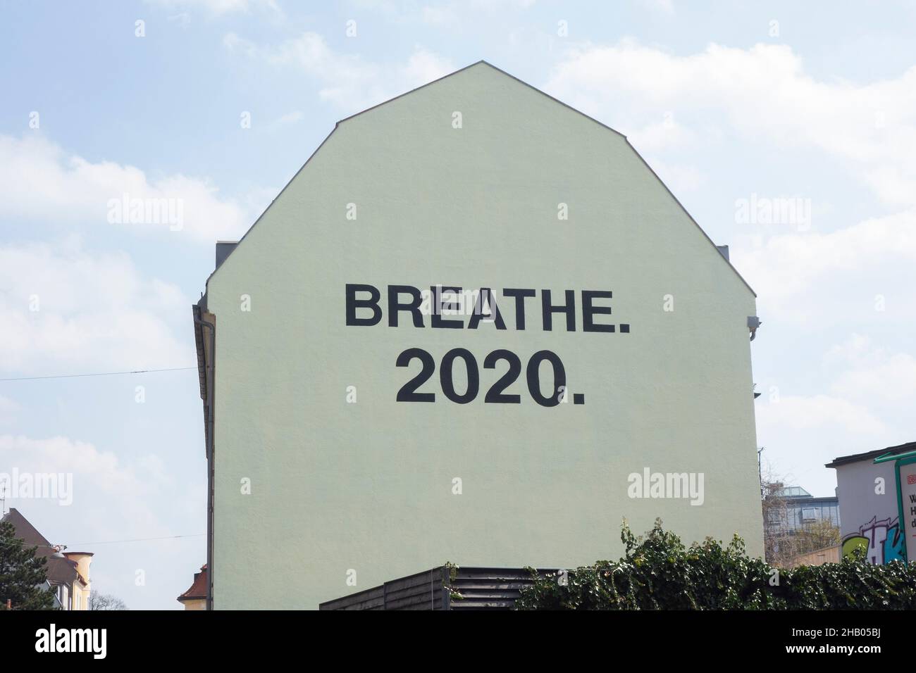 Giant lgrafitti on a house wall during the corona pandemic, saying BREATHE 2020, Munich, Bavaria, Germany, Europe.. Stock Photo