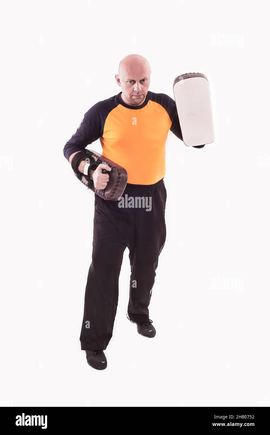 Martial arts trainer holding kickshield Stock Photo Alamy