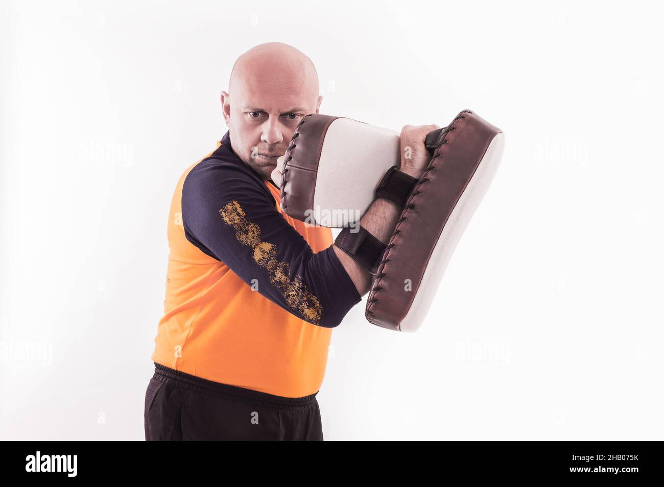 Martial arts trainer holding kickshield Stock Photo Alamy