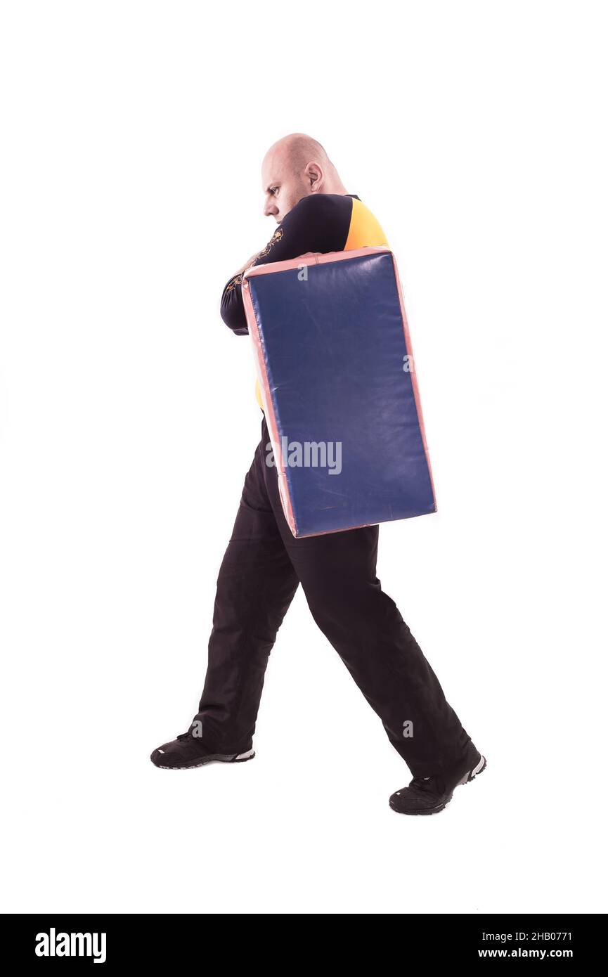 Martial arts trainer holding kickshield Stock Photo Alamy