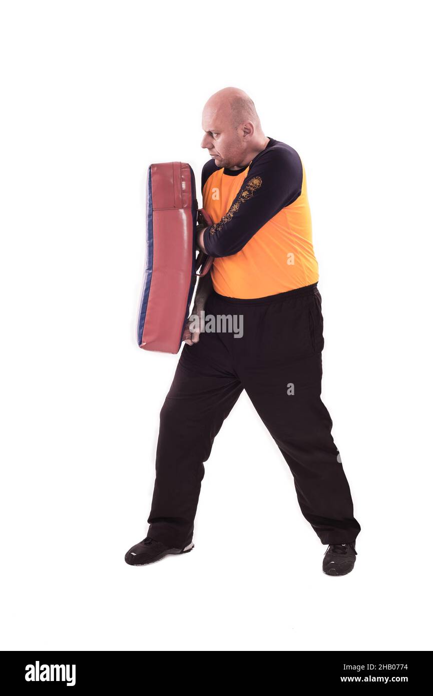Martial arts trainer holding kickshield Stock Photo Alamy