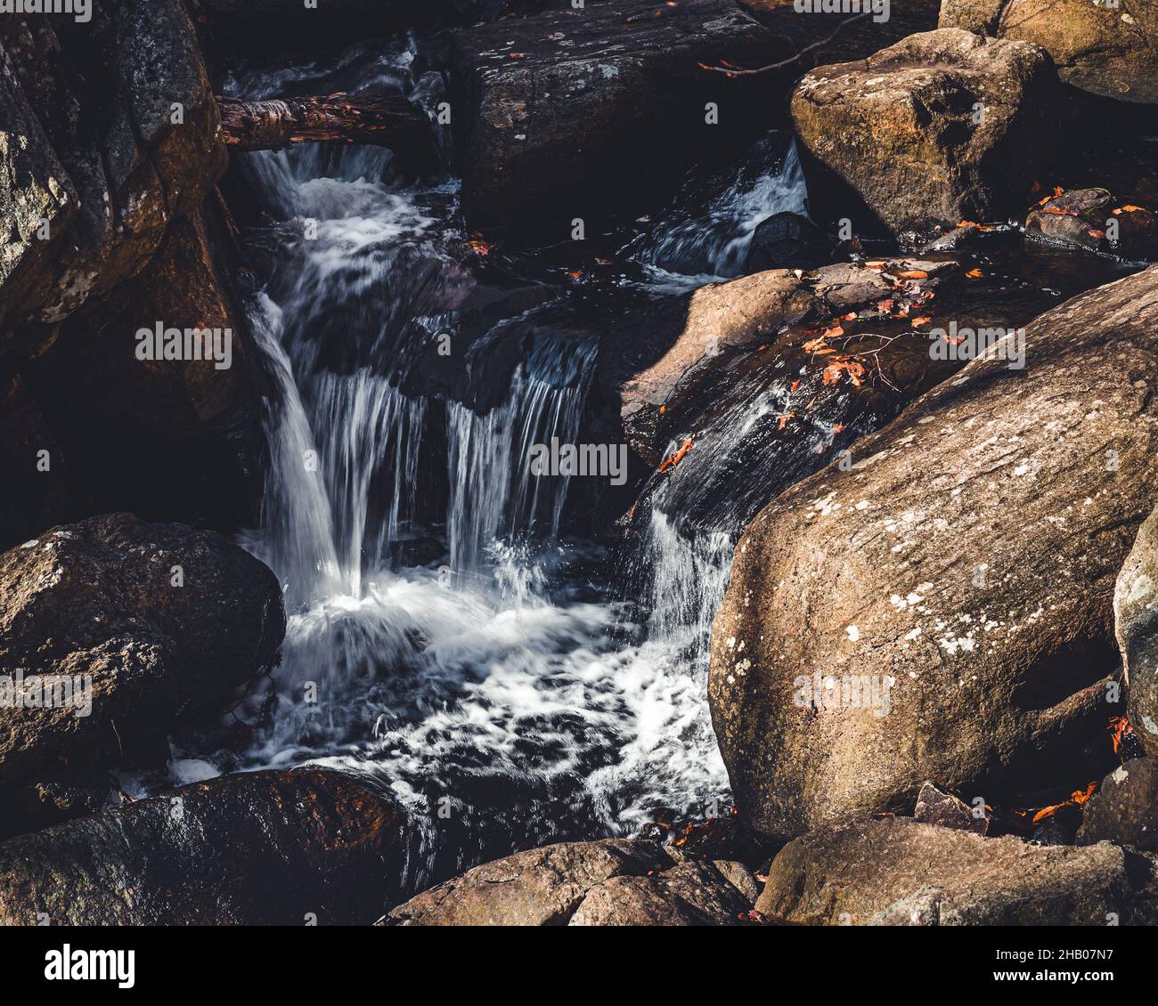 Small waterfall in the rocks Stock Photo - Alamy