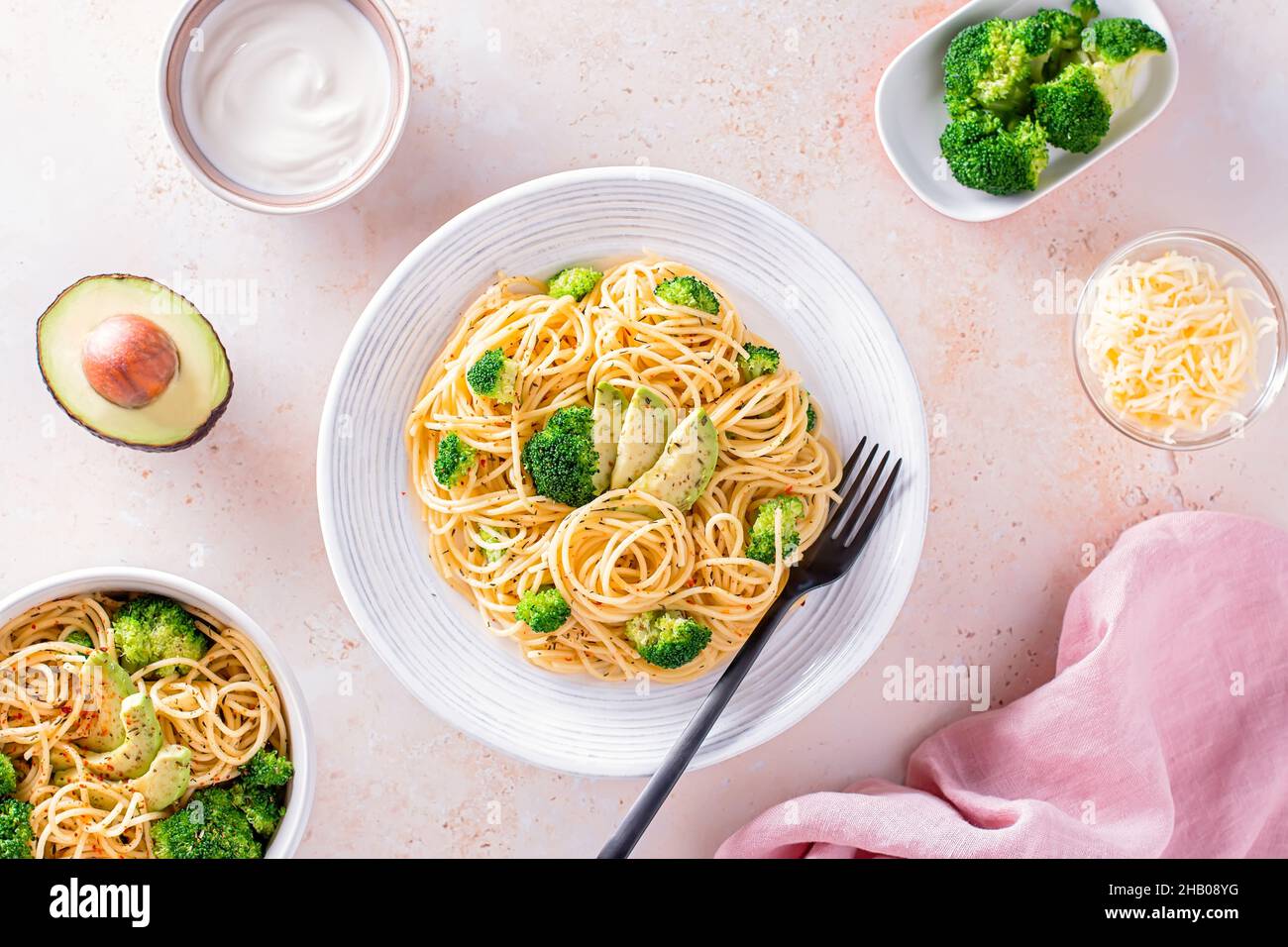 Broccoli and avocado pasta with grated cheese, healthy green meatless