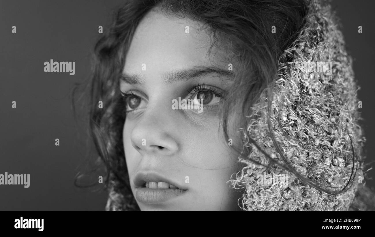 Grayscale shot of a Caucasian female with a headscarf with patterns Stock Photo