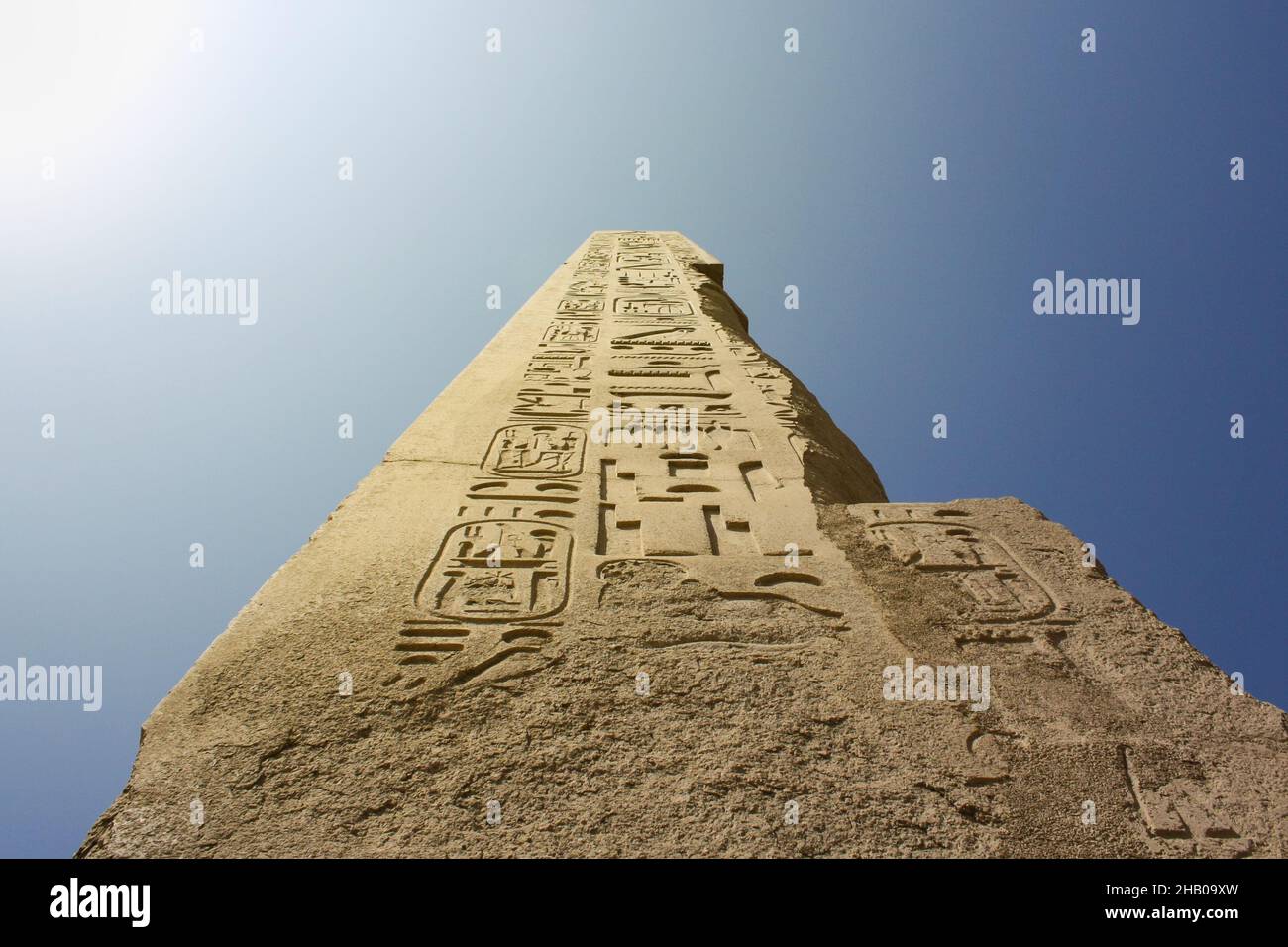 Karnak temple complex in Luxor, Egypt. Ancient stella with hieroglyphs on the blue sky. Stock Photo
