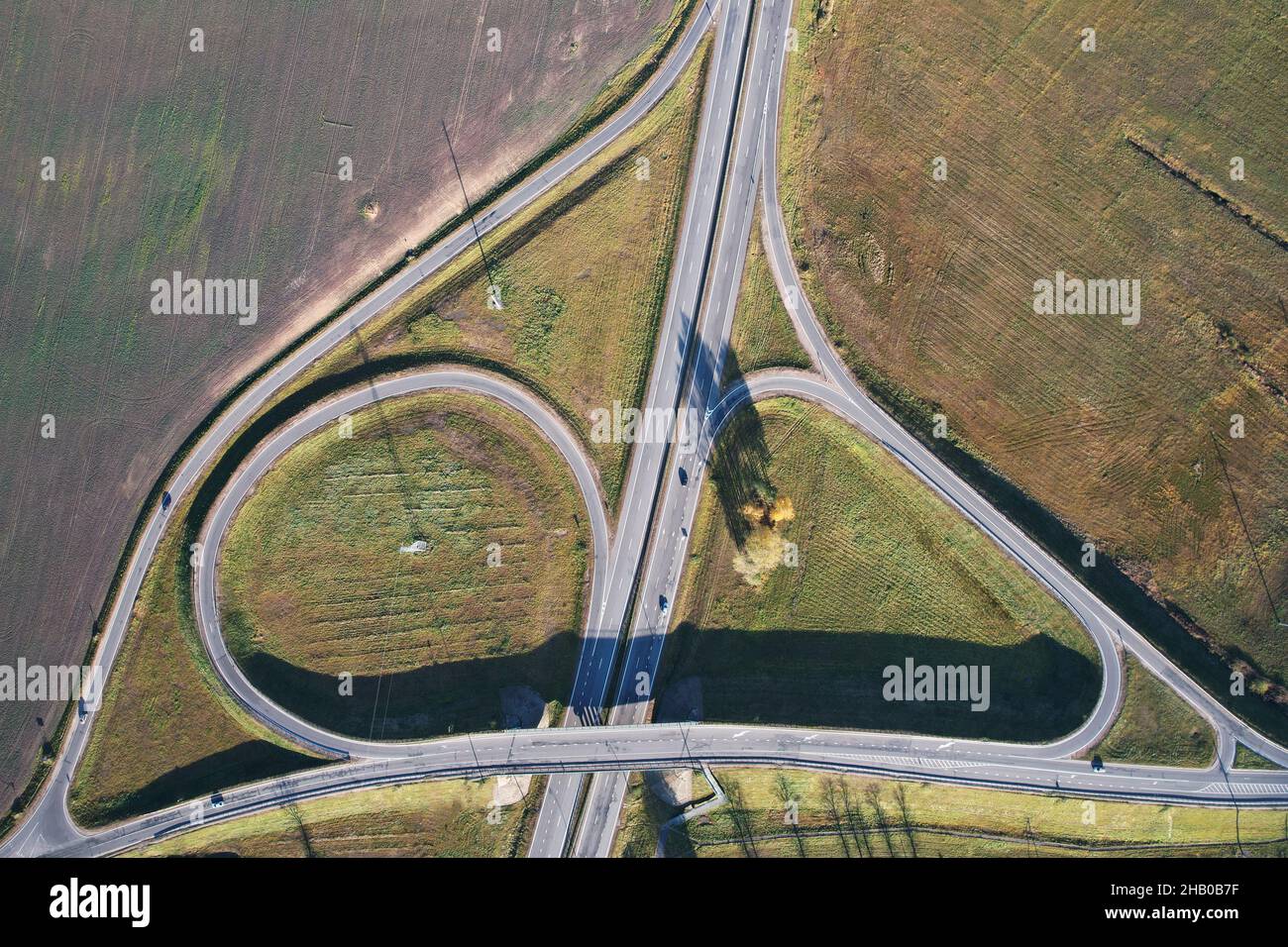 Crossroad on highway aerial drone above view on sunny day Stock Photo