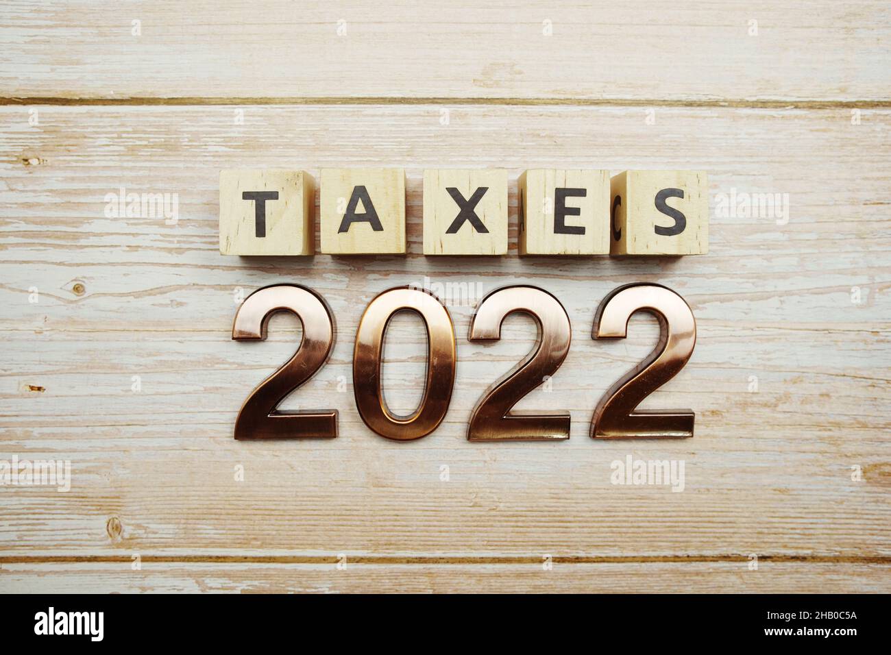 Taxes 2022 alphabet letter on wooden background Stock Photo