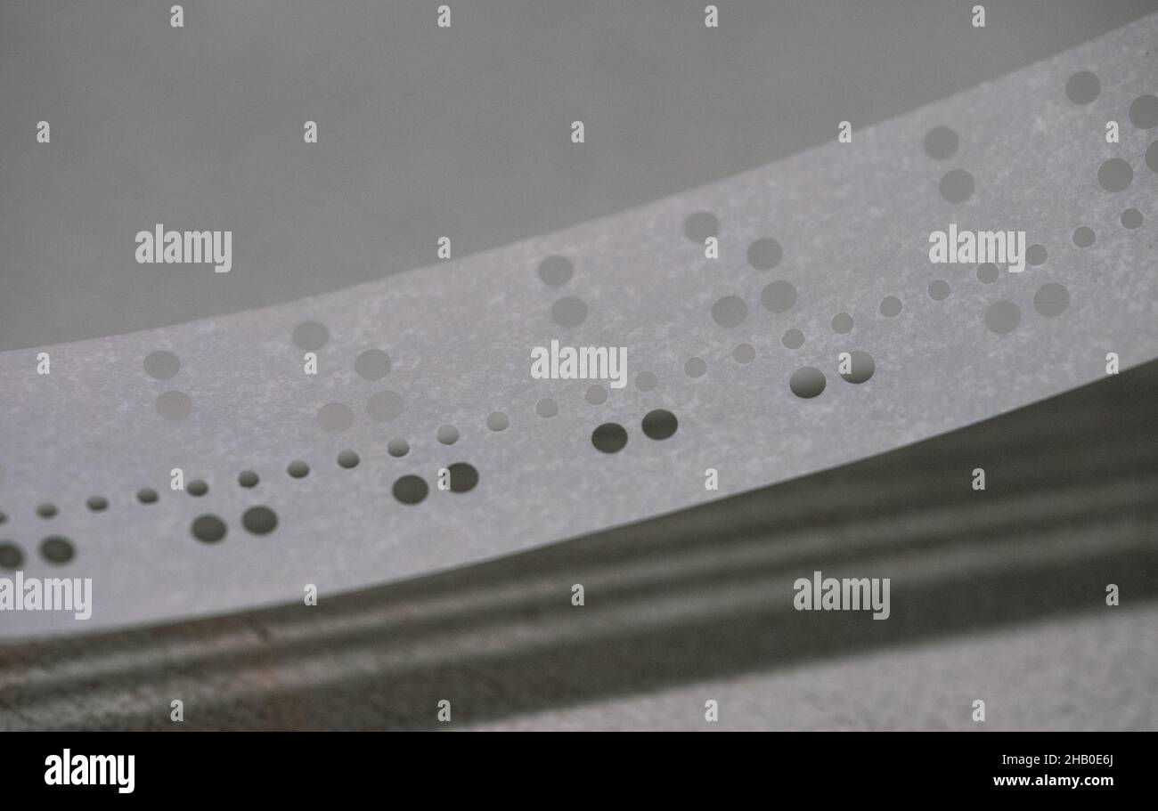 Spool of punched paper tape used for programming early computers Stock