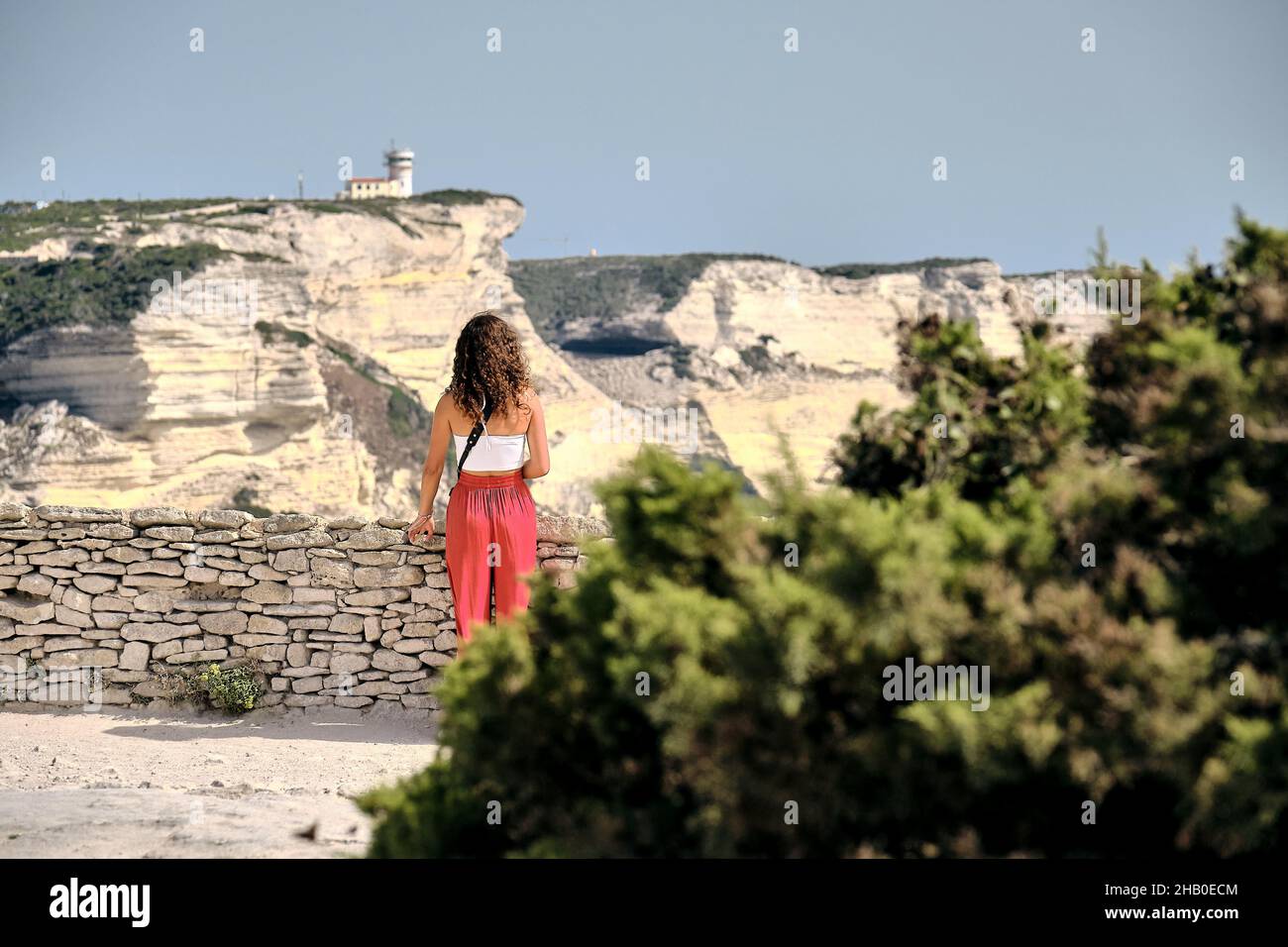 Looking To Woman looking to the Limestone Cliffs of Bonifacio Stock Photo - Alamy