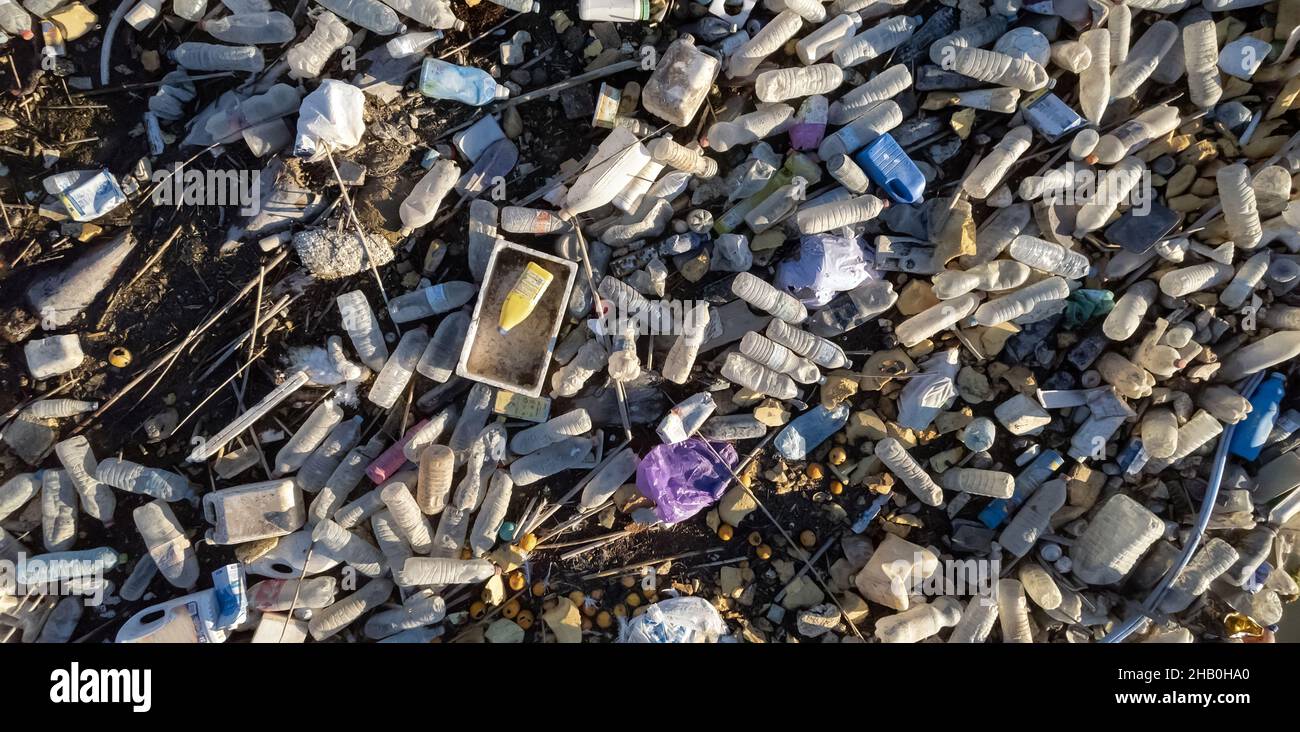 Aerial shot, scrap-heap pile of plastic rubbish. Top view lot bottles, pollution debris outdoors. Global damage, environmental pollution concept. Cost Stock Photo