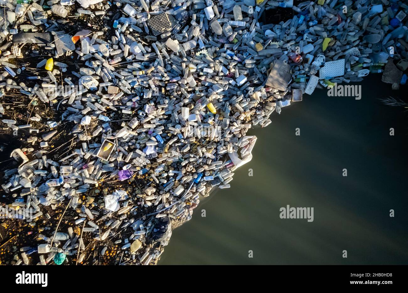 Aerial shot view waterfront scrapheap pile plastic bottles rubbish
