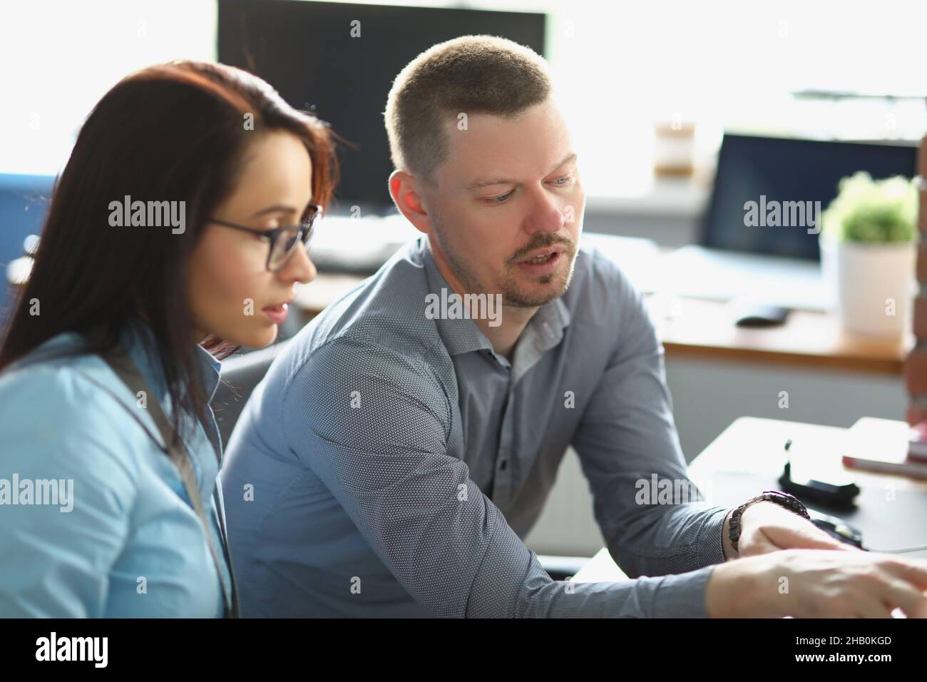 Smart man colleague help coworker with working process, explain ...