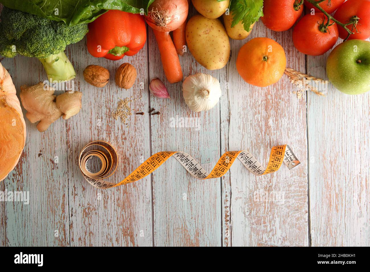 Diet concept with healthy food and measuring tape on wooden table. Top view. Horizontal composition. Stock Photo