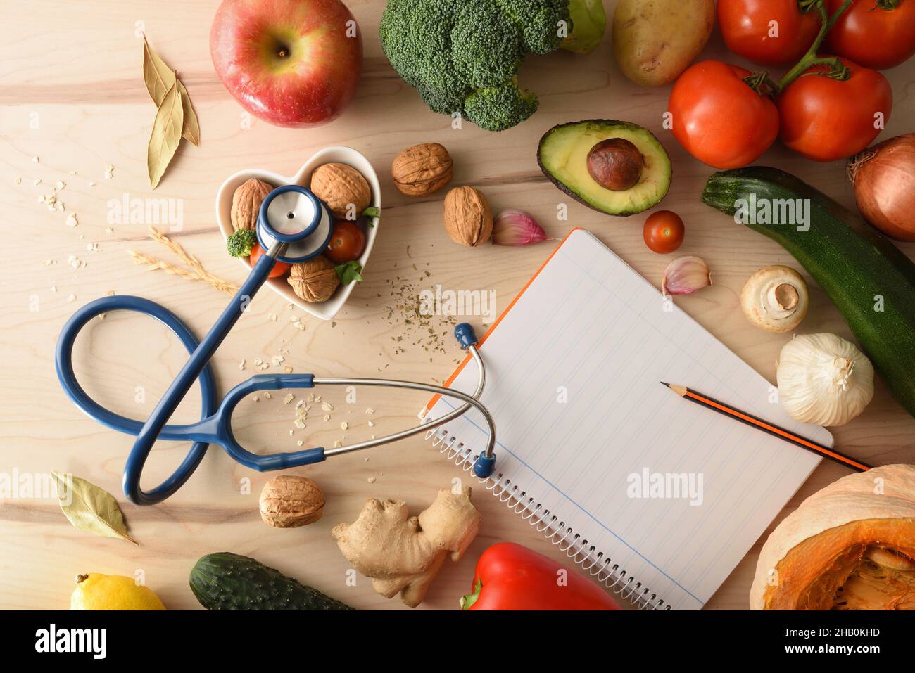 Health care plan with natural balanced food with fruits and vegetables and notepad with blank sheet on wooden table. Top view. Horizontal composition. Stock Photo