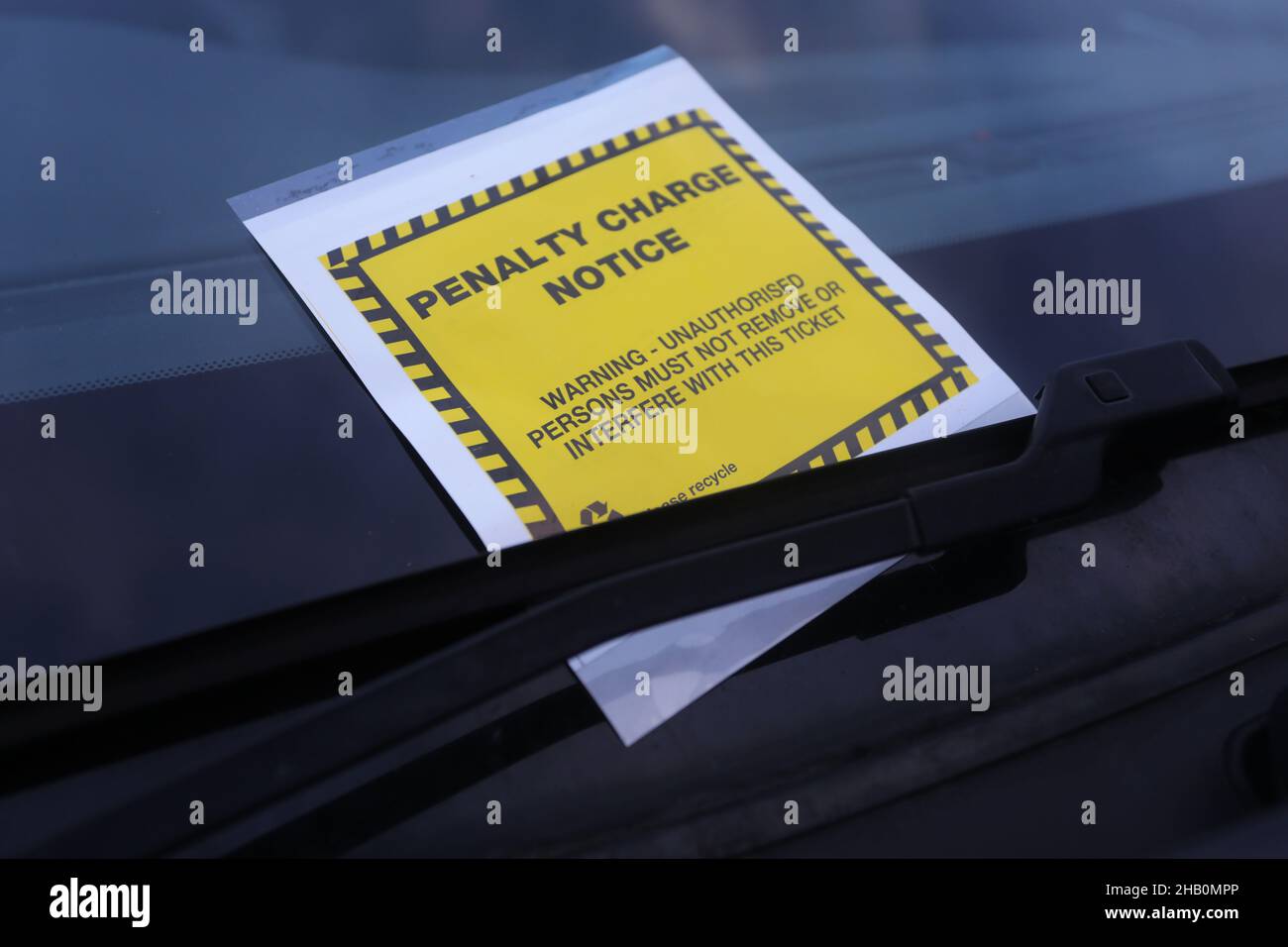 A parking ticket / penalty charge notice pictured on a car in Portsmouth, Hampshire, UK. Stock Photo
