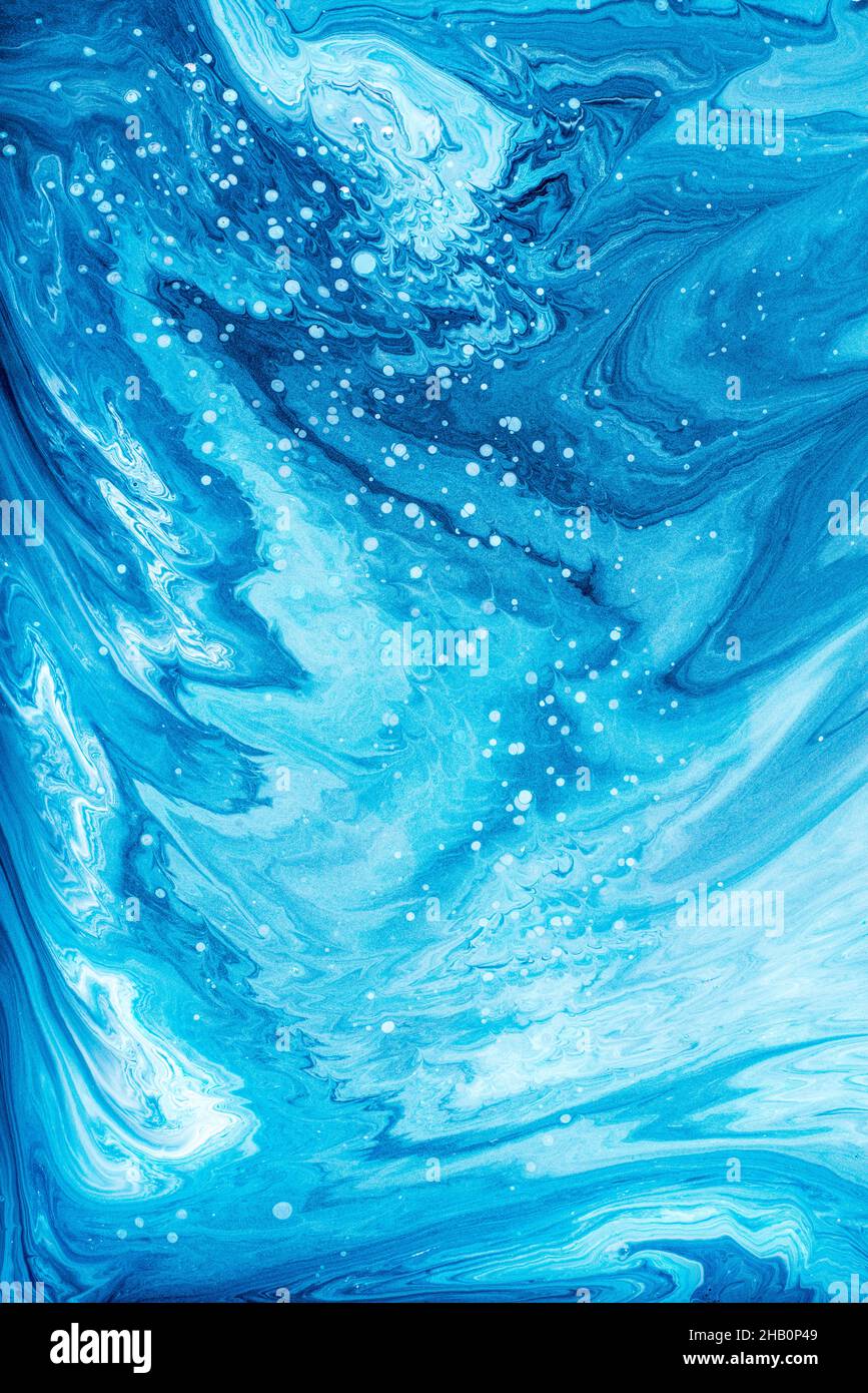 Free flowing blue and white acrylic paint artwork. Abstract background or texture. Stock Photo