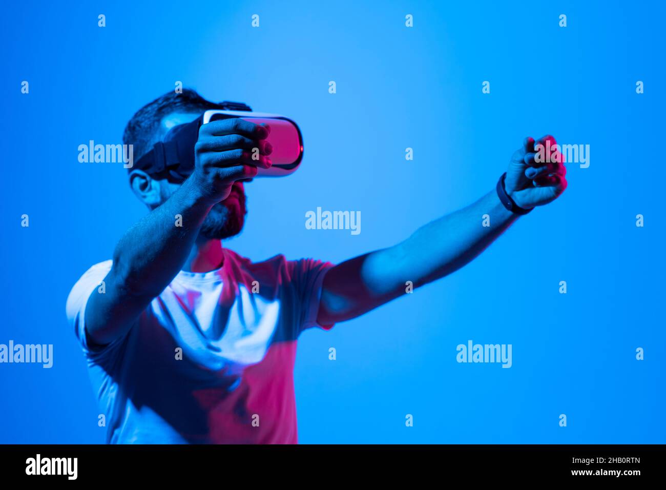 Bearded young man wearing virtual reality goggles in modern desing ...