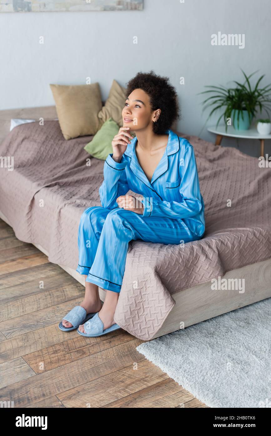 African american woman sitting on bed hi-res stock photography and ...