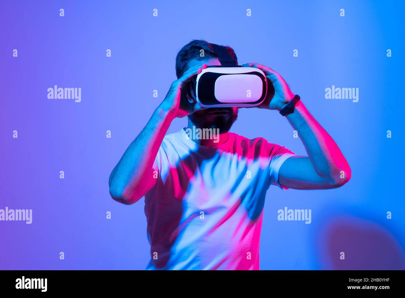 Young man with beard uses glasses of virtual reality to communicate ...