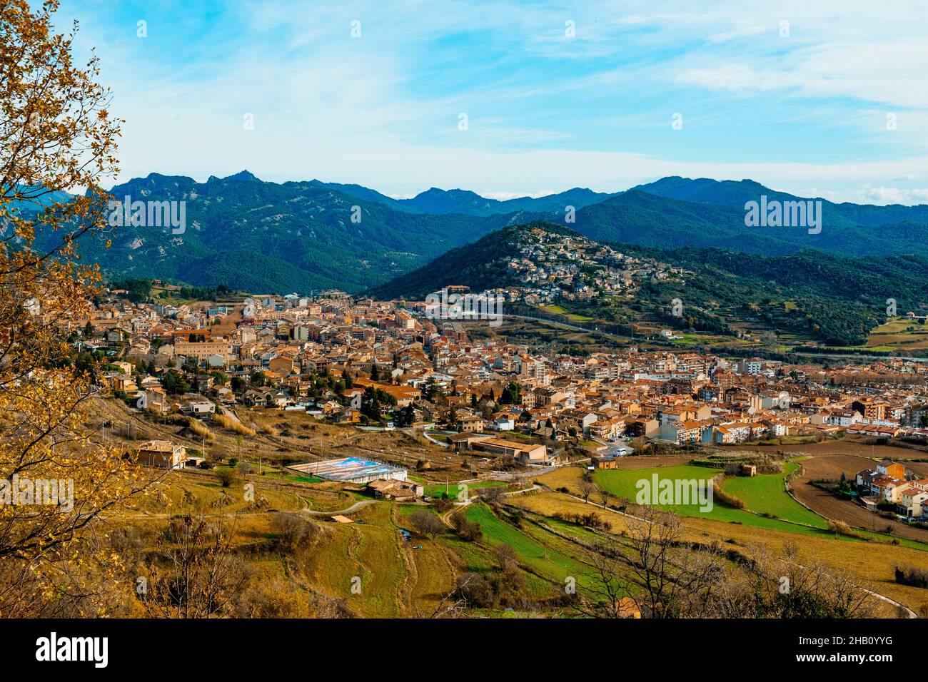 an aerial view of Berga, in Catalonia, Spain, in a valley, with the moutains Serra de Campons and Serra de Picancel mountain in the background Stock Photo