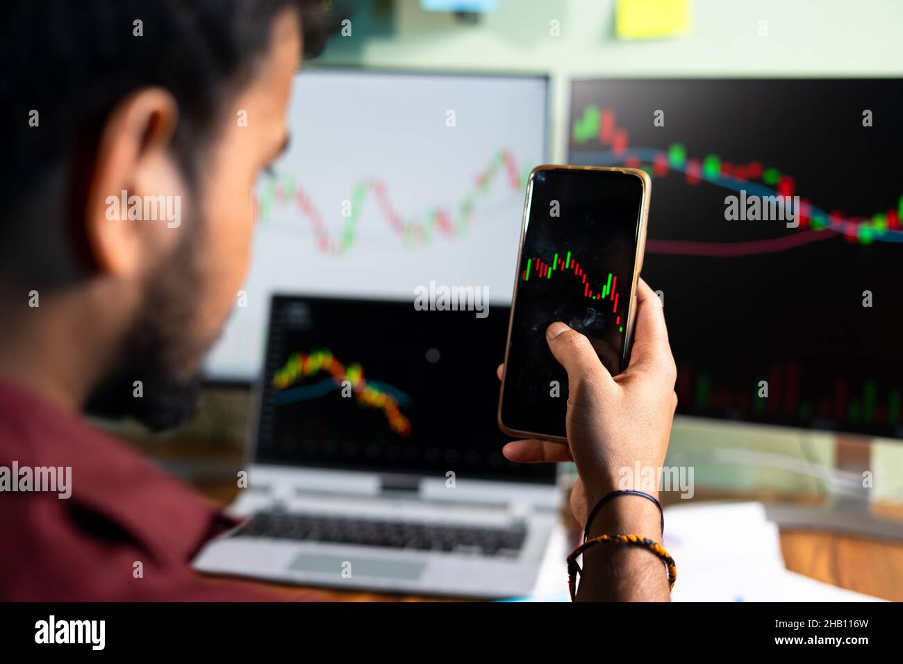 selective focus on hand, trader watching stock market candlestick patterns - concept of Investing money on shares using technical analysis, trading or Stock Photo