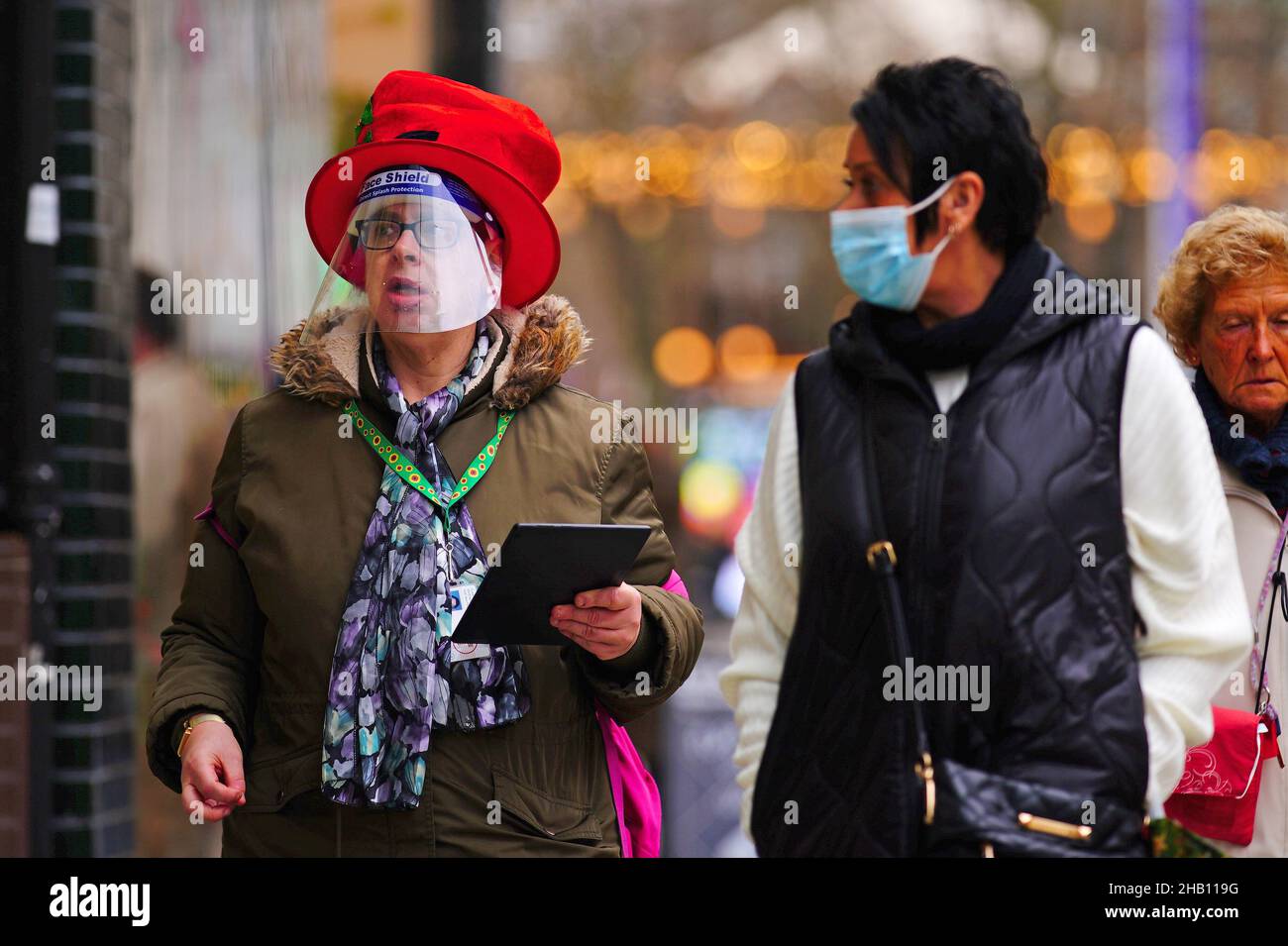 Christmas shoppers wearing face coverings in the centre of Cardiff, Wales, where people have been told to prepare for more restrictions in the coming weeks as the country faces an impending 'tsunami' from the Omicron variant of Covid-19. Picture date: Thursday December 16, 2021. Stock Photo