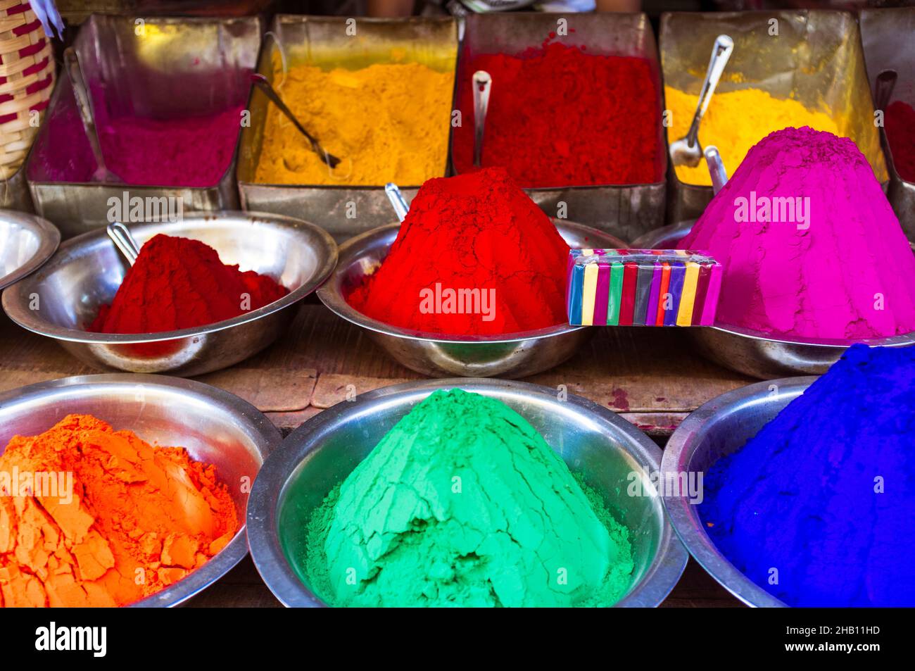 Mysore, Karnataka, India : Conical piles of kumkum coloured powder used for bindi dots for sale at Devaraja market. Stock Photo