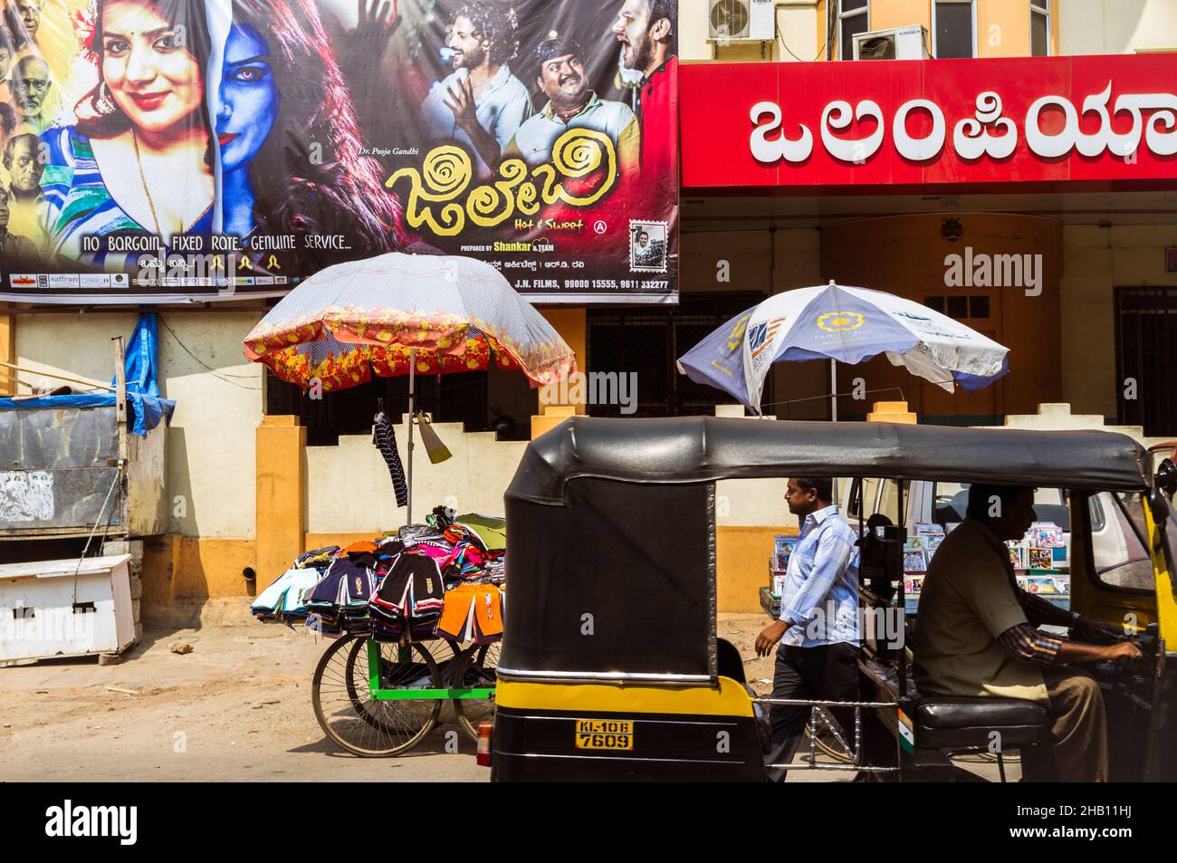 Mysore, Karnataka, India : An Auto-rickshaw rides past the Olympia cinema in Central Mysore. Stock Photo