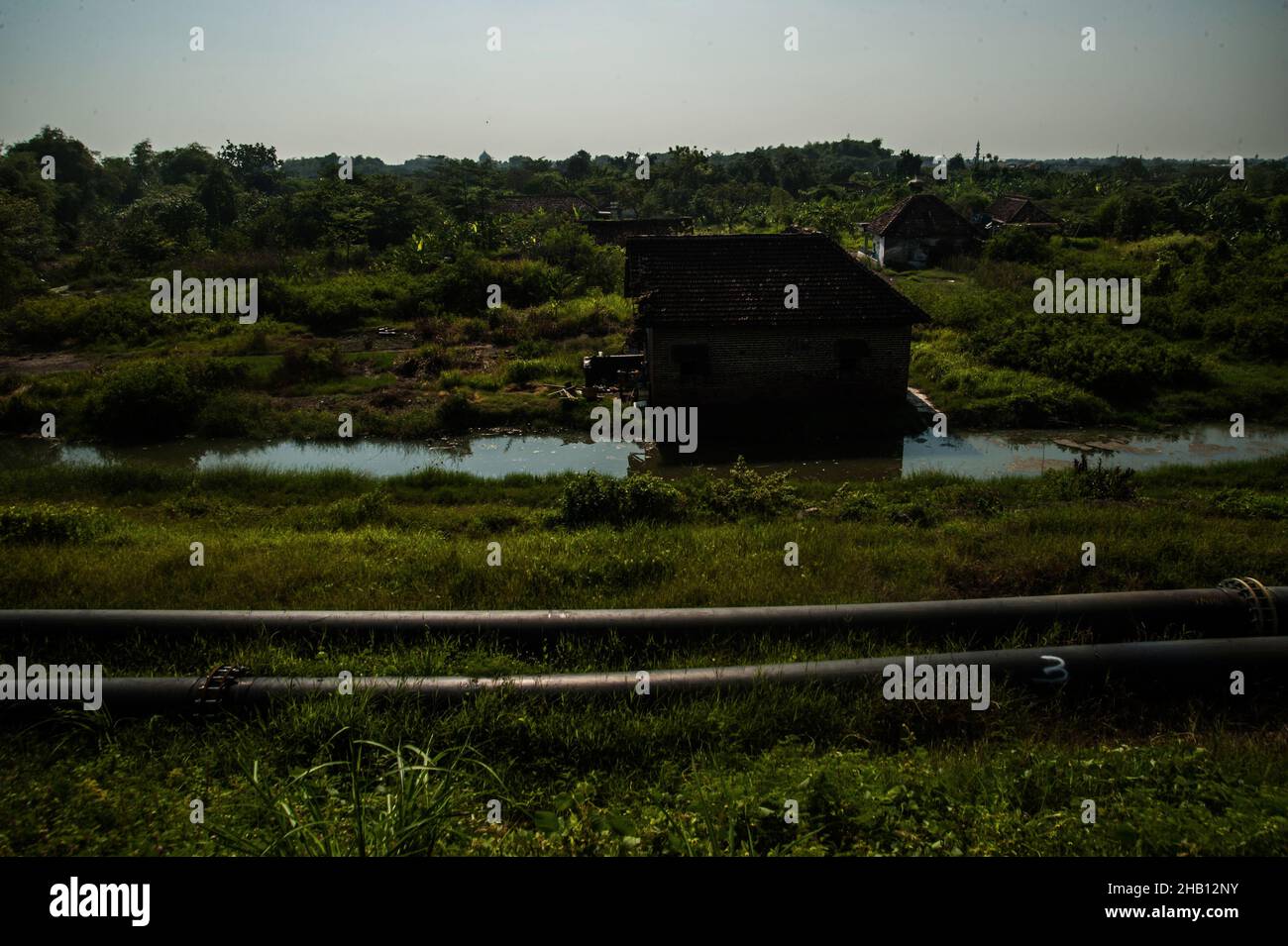 Photo dated October 19, 2016 - The debris home from the past settlement seen burried amid the Lapindo volcanic mudflow disaster area in Sidoarjo, East Java province, Indonesia. Since May 29, 2006 until now, as 1,143.3 hectares area land has changes be the natural territory of the world's largest mud volcano were belches water, oil, methane gas and mud everytime. The geological activity is a contributor to methane gas emissions amount as the largest natural gas manifestation on earth, based on the study report published in the journal Scientific Reports on February 18, 2021. Photo by Sutanta Ad Stock Photo