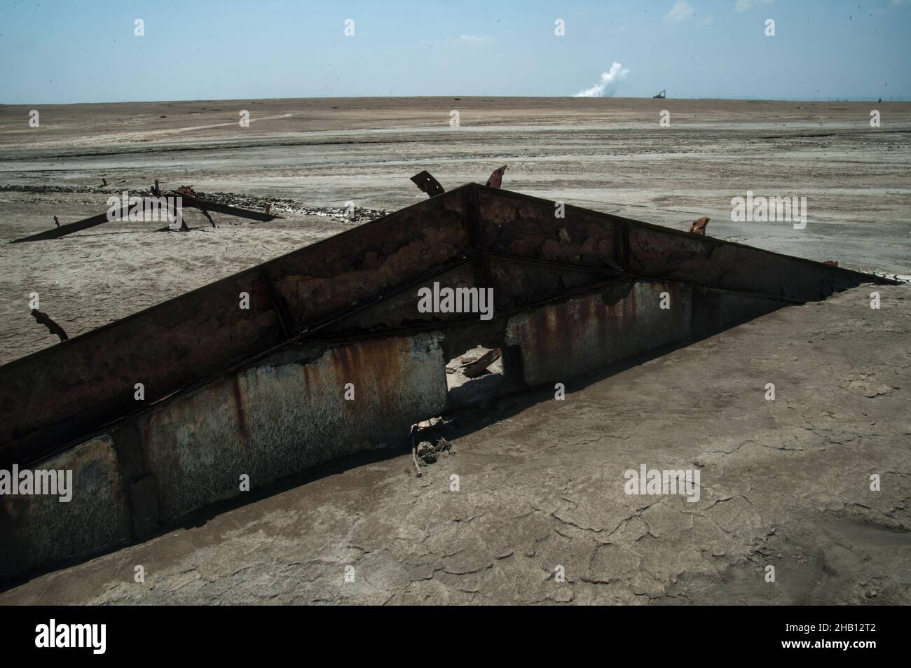 Photo dated October 19, 2016 - The debris home from the past settlement seen burried amid the Lapindo volcanic mudflow disaster area in Sidoarjo, East Java province, Indonesia. Since May 29, 2006 until now, as 1,143.3 hectares area land has changes be the natural territory of the world's largest mud volcano were belches water, oil, methane gas and mud everytime. The geological activity is a contributor to methane gas emissions amount as the largest natural gas manifestation on earth, based on the study report published in the journal Scientific Reports on February 18, 2021. Photo by Sutanta Ad Stock Photo
