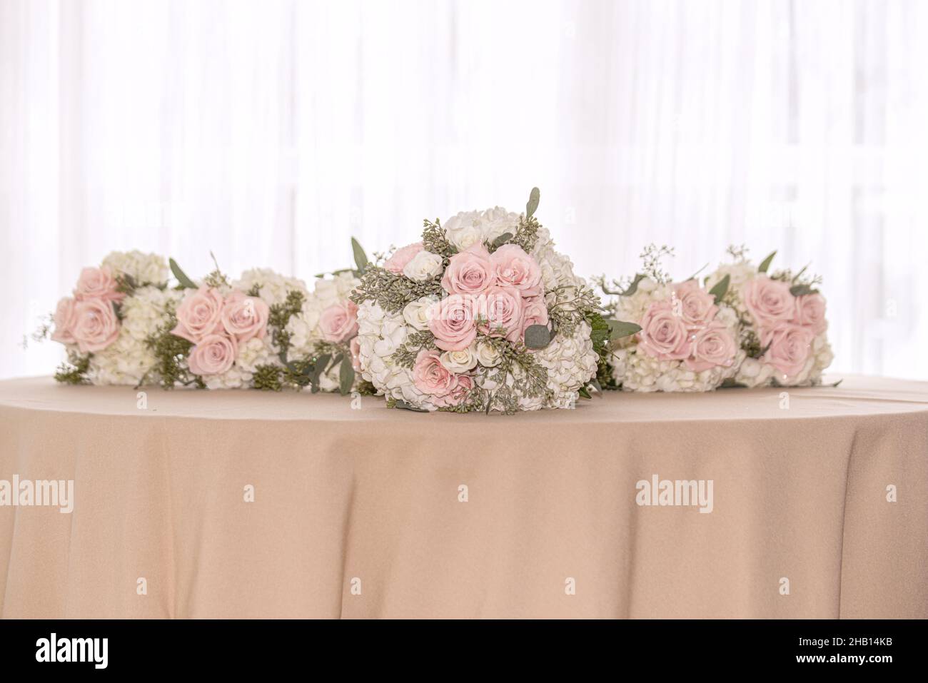 Pink and white roses with white hydrangea bridal party bouquets lined ...