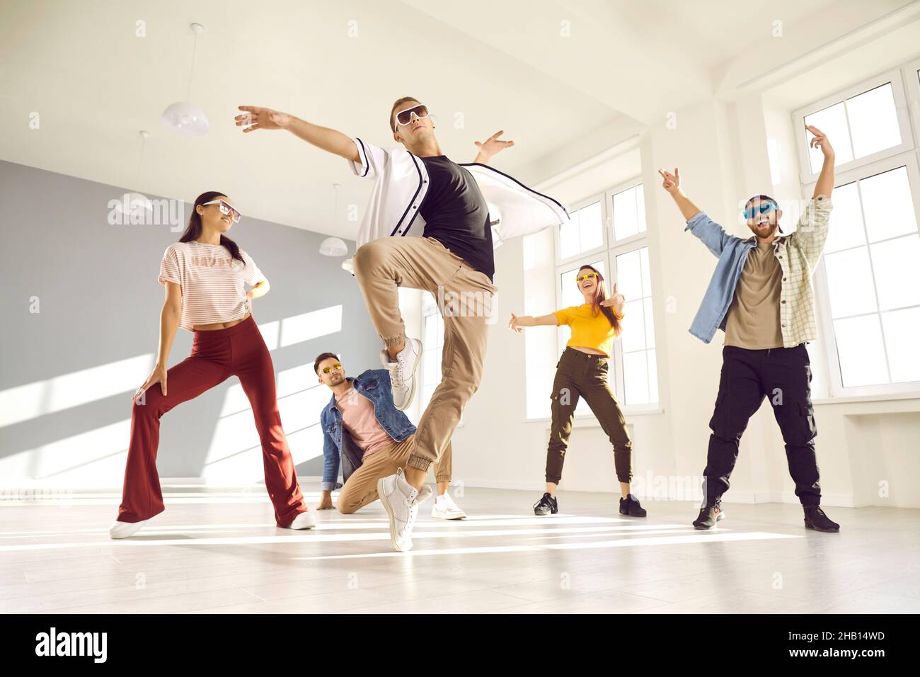 Cool male dancer doing ballet tip toe turn during break dance practice in studio Stock Photo