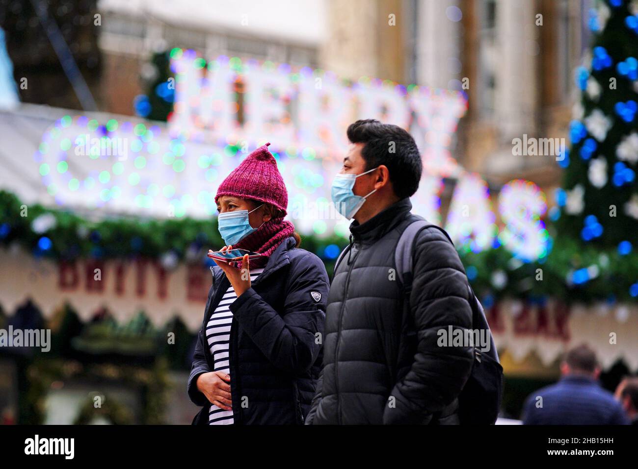 Christmas shoppers walk through the centre of Cardiff, Wales, where people have been told to prepare for more restrictions in the coming weeks as the country faces an impending 'tsunami' from the Omicron variant of Covid-19. Picture date: Thursday December 16, 2021. Stock Photo