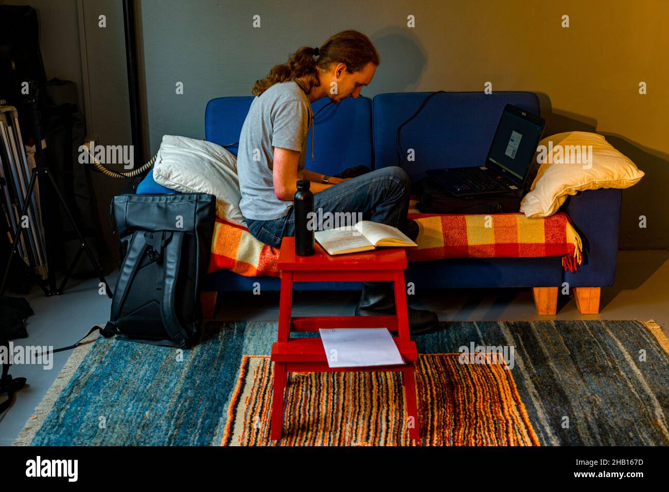Tilburg, Netherlands. Young adult caucasian male working with his