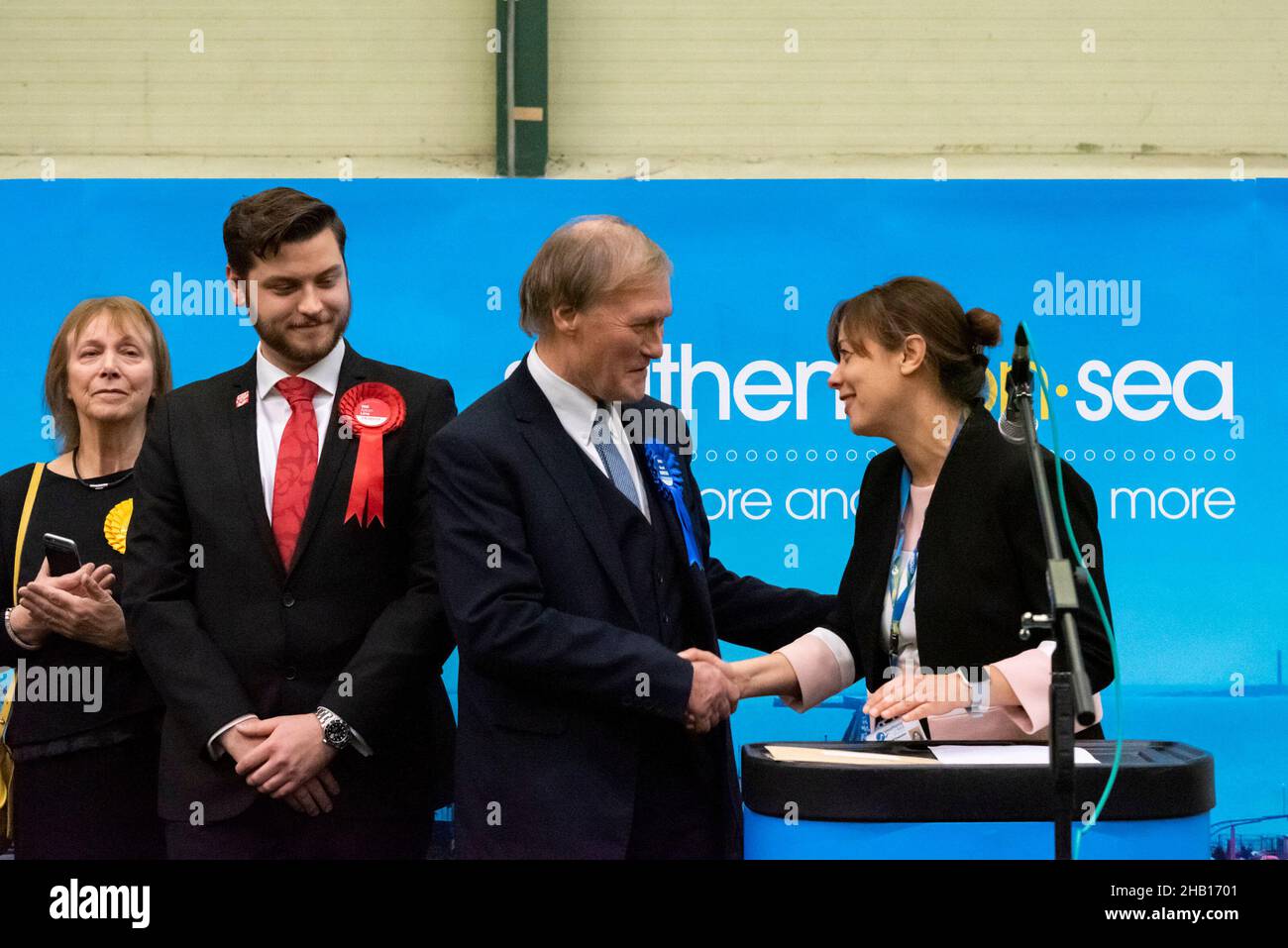 MP David Amess at the UK General Election, winning the Southend West constituency, being congratulated by the returning officer, with party candidates Stock Photo