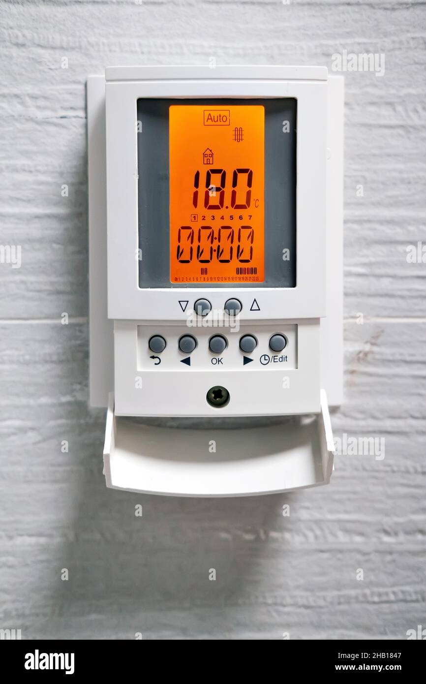 Close up vertical view programmable digital screen of warm floor inside domestic room. Under floor heat temperature information. Home automation or do Stock Photo